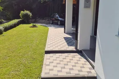 a walkway outside of a house with a car parked at Villa DIAL Lohovo-dvoslap in Bihać