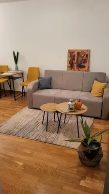 a living room with a couch and a table at Apartman La Valletta, Doboj in Doboj