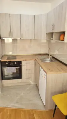 a kitchen with a sink and a stove at Apartman La Valletta, Doboj in Doboj