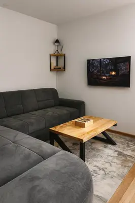 a living room with a couch and a coffee table at Apartman Monti Vlašić in Vlasic