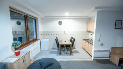 a kitchen with a table and chairs in a room at Apartman Monti Vlašić in Vlasic