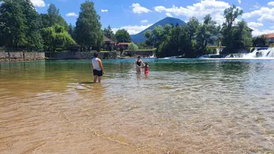 a group of three people standing in the water at Kuca za odmor Šušnjar in Ripač