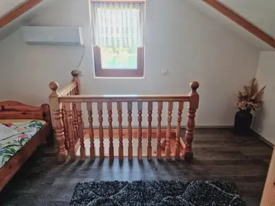 a wooden staircase in a room with a window at Kuca za odmor Šušnjar in Ripač