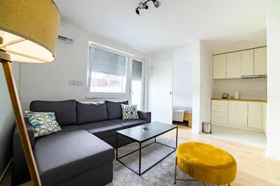 a living room with a couch and a table at Sun Square Apartments in Tuzla