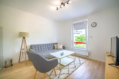 a living room with a couch and a table at Sun Square Apartments in Tuzla