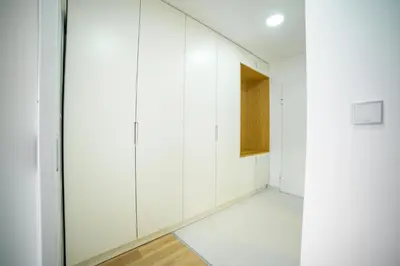 an empty room with white walls and a door at Sun Square Apartments in Tuzla