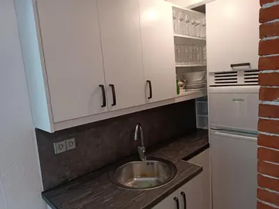 a kitchen with a sink and a refrigerator at Cottage Auto Camp Vinac in Jajce