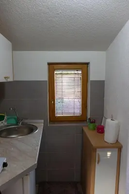 a bathroom with a sink and a window at Orhideja Visoko in Visoko