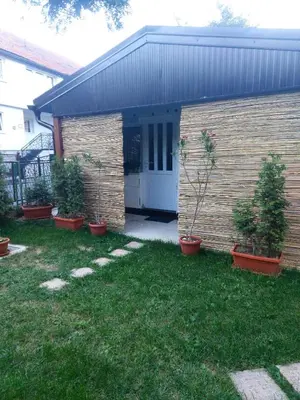 a house with potted plants in front of it at Orhideja Visoko in Visoko