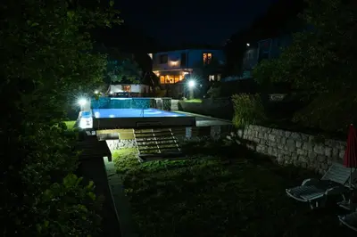 a house with a swimming pool at night at Prenoćište Slapovi in Jajce