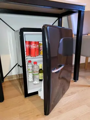 an open refrigerator under a table with drinks in it at Prenoćište Slapovi in Jajce
