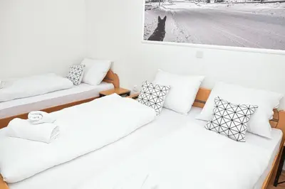 two beds in a room with a picture on the wall at Prenoćište Slapovi in Jajce