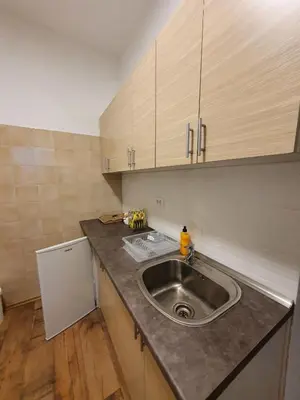 a kitchen counter with a sink and a refrigerator at Apartmani Sarti Banja Luka in Banja Luka