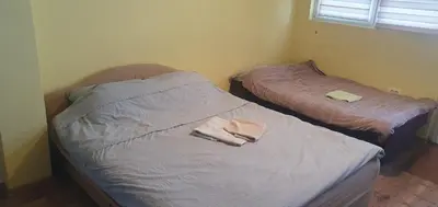 two beds in a room with towels on the bed at Apartmani Sarti Banja Luka in Banja Luka