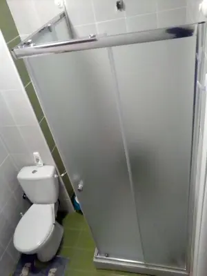 a bathroom with a toilet and a sliding shower door at Apartman Brezuljak Banja Luka Cokorska polja in Macanovići
