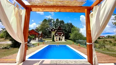 a house with a swimming pool in front of a house at Apartman Brezuljak Banja Luka Cokorska polja in Macanovići