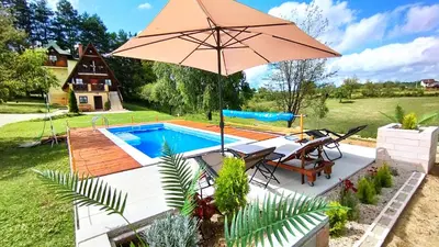 a pool with a table and an umbrella at Apartman Brezuljak Banja Luka Cokorska polja in Macanovići