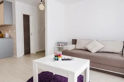 a living room with a white table and a couch at Apartment Andrej in Tomislavgrad