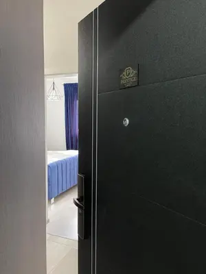 a black refrigerator in a room with a bedroom at Prestige Apartment Teslic in Teslić