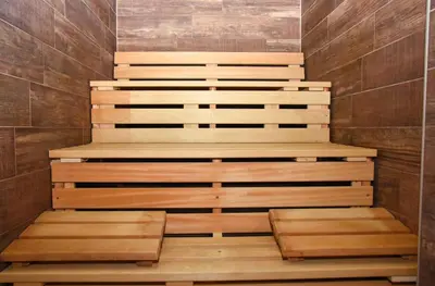 a staircase in a sauna with wooden steps at Hotel PALACE in Velika Kladuša