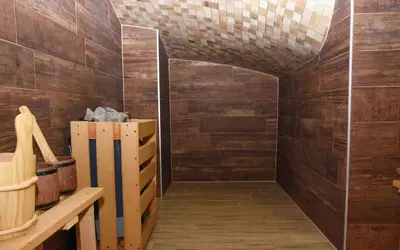 a room with wooden walls and a hallway with wood floors at Hotel PALACE in Velika Kladuša