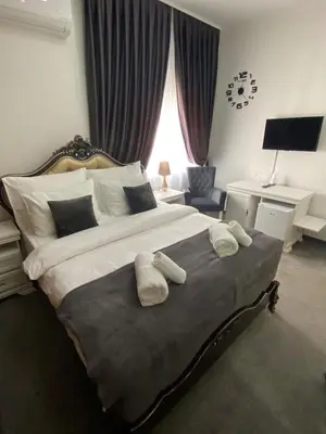 a bedroom with a large bed with two towels on it at Hotel PALACE in Velika Kladuša