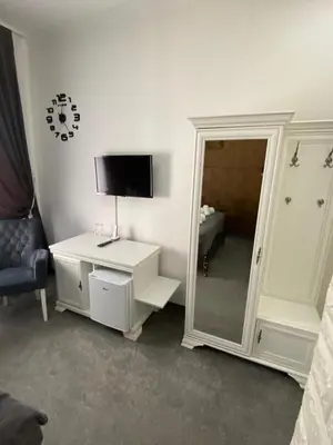 a room with a white dresser and a mirror at Hotel PALACE in Velika Kladuša
