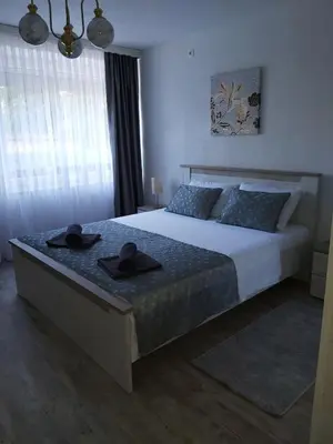 a bedroom with a large bed with hats on it at Apartman Alma in Bihać