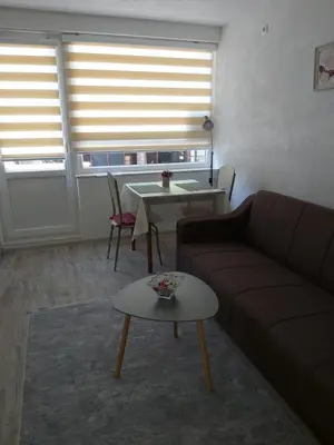 a living room with a couch and a table at Apartman Alma in Bihać