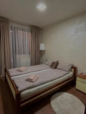 a bedroom with a bed with two towels on it at Apartman Basic Doboj in Doboj