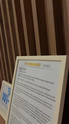 a sign for the national electric company on a table at Apartman Basic Doboj in Doboj