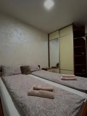 a bedroom with a bed with two towels on it at Apartman Basic Doboj in Doboj