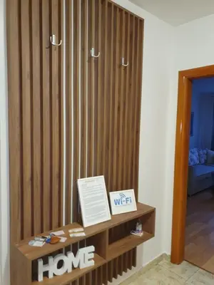 a room with a wood paneled wall with a sign on it at Apartman Basic Doboj in Doboj