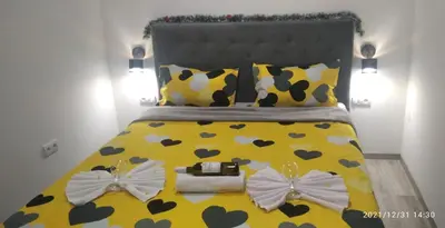 a bedroom with a yellow bed with bows on it at Mars in Banja Luka