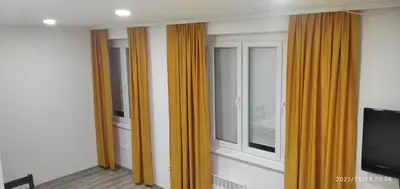 a room with orange curtains and a window at Mars in Banja Luka