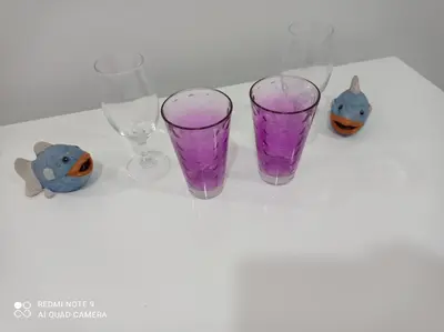 four empty wine glasses sitting on a table at Mars in Banja Luka