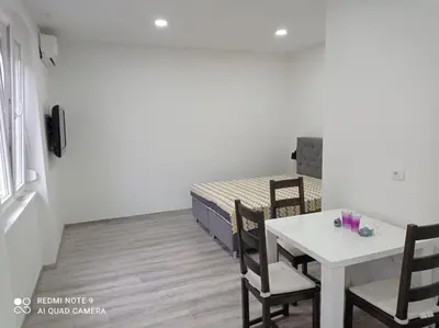 a room with a table and a bed and a table and chairs at Mars in Banja Luka