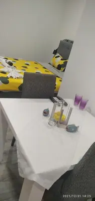 a white table with two chairs and a bed at Mars in Banja Luka