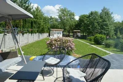 a patio with two chairs and a table and a table at Little Aria in Ripač