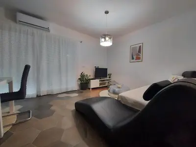 a bedroom with a bed and a chair in it at Little Aria in Ripač