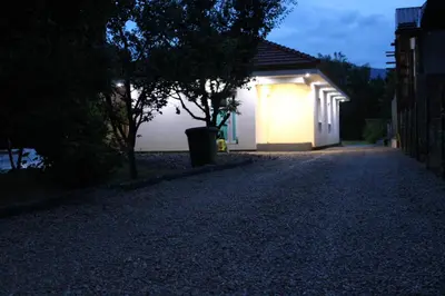 a house with a light on the side of a road at Little Aria in Ripač