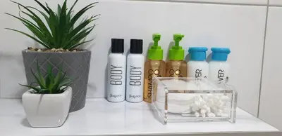 a group of bottles on a counter next to a potted plant at Apartman Alina Comfort in Banja Luka