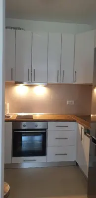 a kitchen with white cabinets and a microwave at Apartman Alina Comfort in Banja Luka