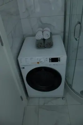 a washing machine in a bathroom with towels on it at Apartman Alina Comfort in Banja Luka