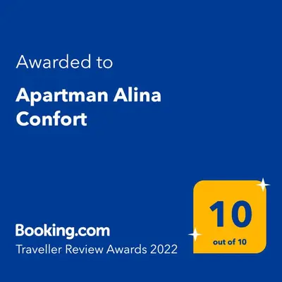 a yellow sign with the text awarded to armenian alma comfort at Apartman Alina Comfort in Banja Luka