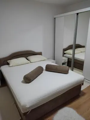 a bed with two pillows on it with a mirror at Villa Ramea in Kovačevo Polje