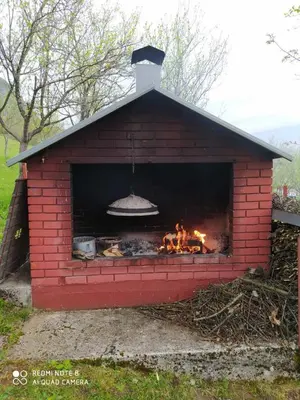 a red brick oven with a fire in it at Villa Ramea in Kovačevo Polje