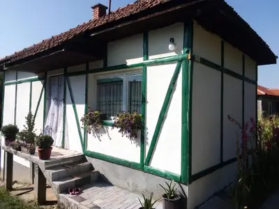 a small house with a green and white window at Bazeni-Etno selo u Visokom in Visoko