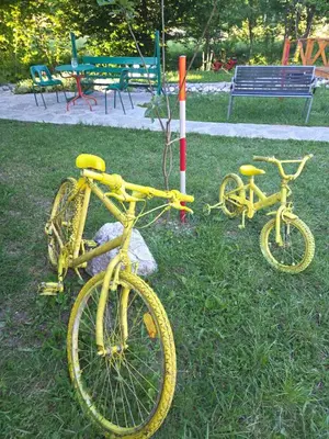 two yellow bikes parked in the grass in a park at Vikendica, Bazen, Šedrvan, Rafting na Uni, Quad in Bihać