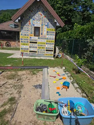 a toy play house with a building in the background at Vikendica, Bazen, Šedrvan, Rafting na Uni, Quad in Bihać
